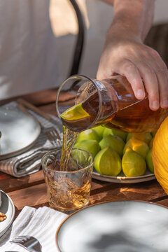 Pouring tea during a gourmet appetizer spread