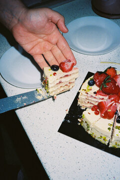 Slice of berry cake served in hand