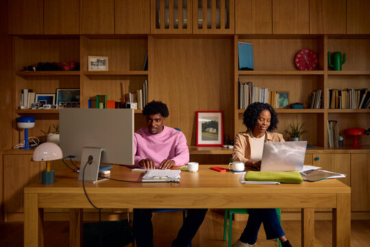 Couple working together in a cozy home office setting