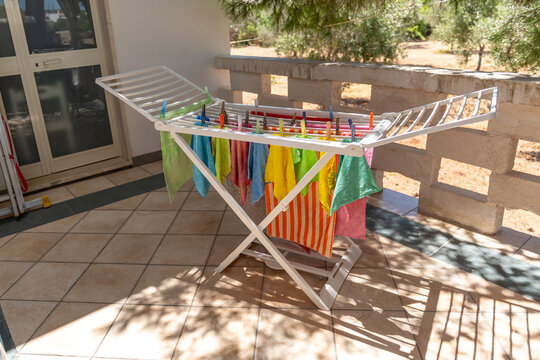 Cleaning rags hanging on a terrace dryer in the summer sun