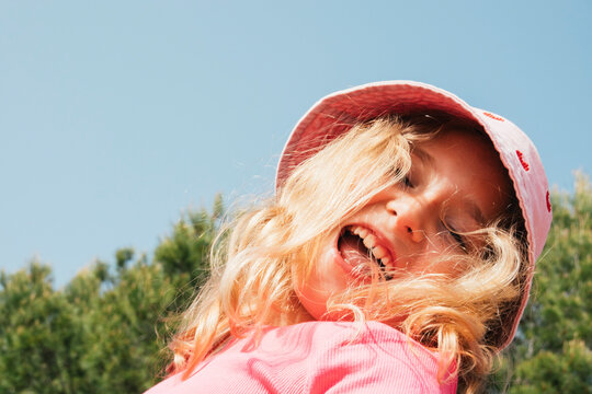 Young girl looking down in sunlight