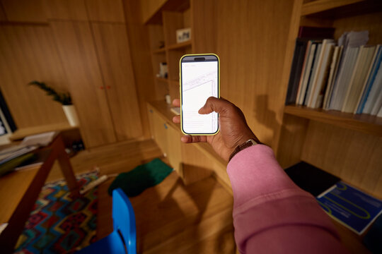 Anonymous person hold a mobile phone with screen turned on