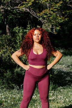 A plus-size woman wearing a serious expression and confident presence