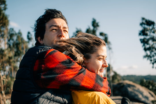 Couple Enjoys Time Together Outdoors Near Trees and Benches