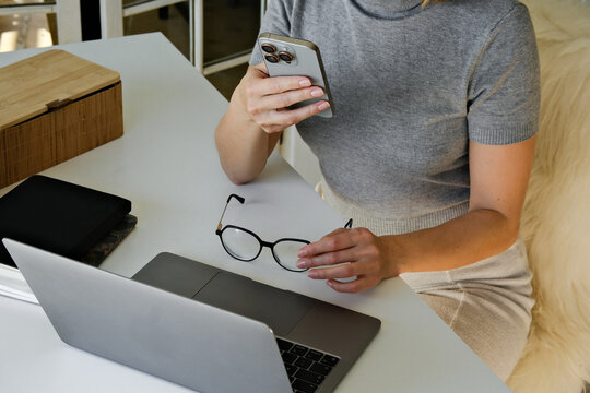 A closeup  from above of a person using a phone. 