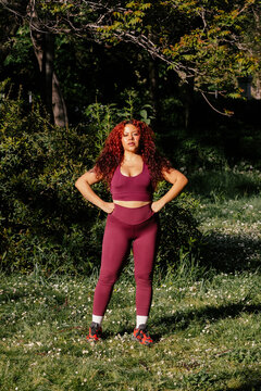 A full-body portrait shows a curvy woman in activewear