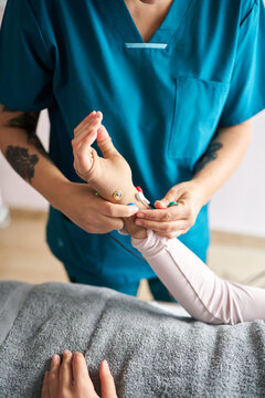 Physiotherapist applying neurostimulation electrodes