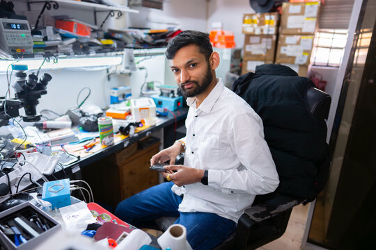 Electronics repair technician in workshop