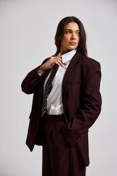 Woman poses in business suit with focus on style and confidence