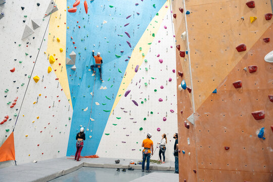 Athletes rock climbing indoors for fitness and training