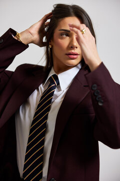Model poses in a studio wearing suit and tie during a photoshoot