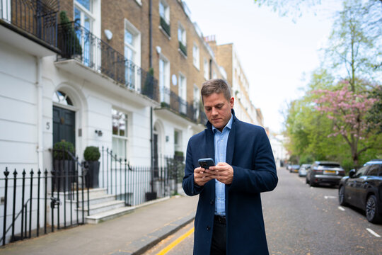 Checking phone on quiet London street