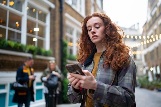 Checking directions on smartphone in London street