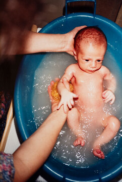 Newborn Baby First Bath Time in Blue Basin