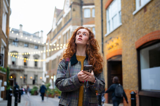 Tourist checking map on smartphone in London