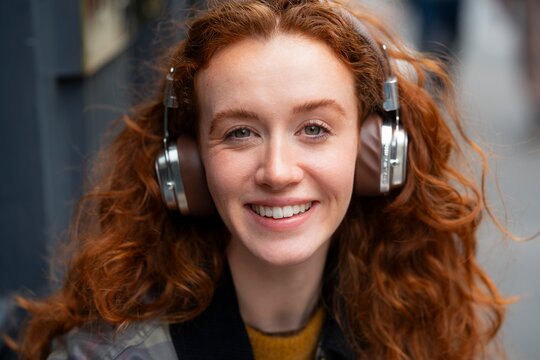Smiling woman with headphones portrait