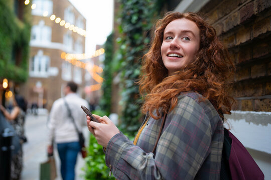 Tourist checking map on smartphone in London