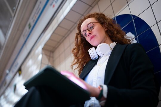 Woman checking time while using tablet