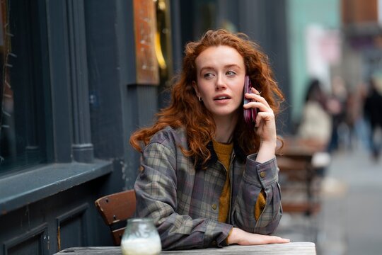 Talking on phone at pub