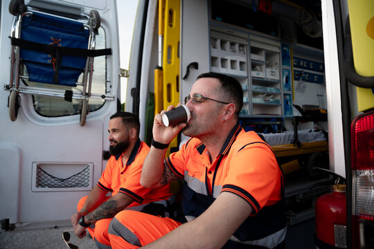 Paramedics taking break drinking coffee