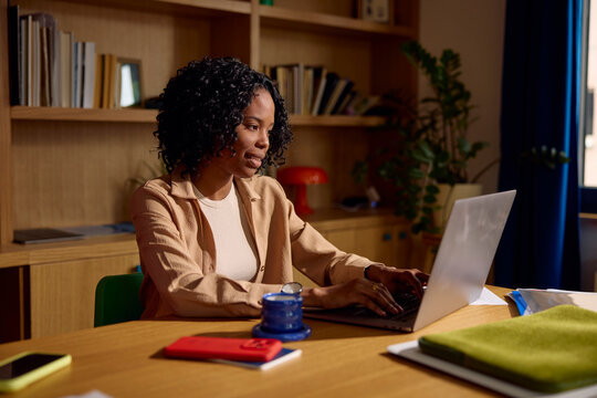 Female Using Laptop at Home Office Desk