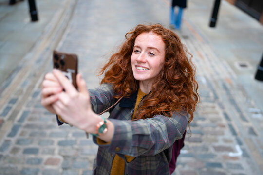 Taking selfie on cobblestone street in London