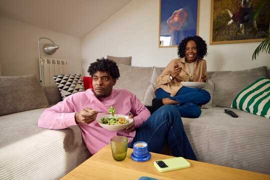 Couple eats together in the living room