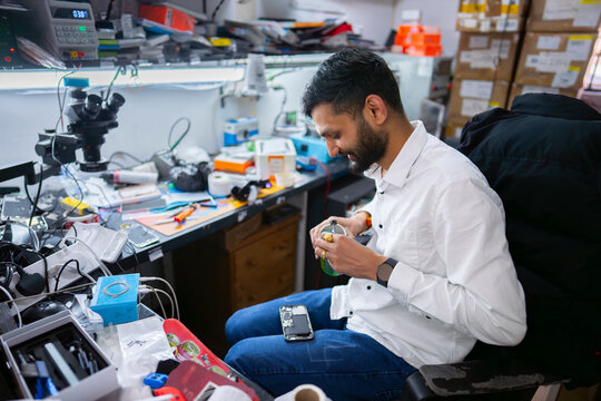 Phone repair technician working in workshop