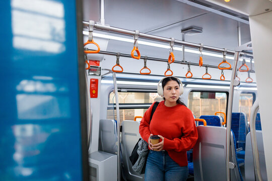 Woman with coffee on train
