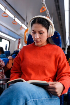 Woman reading a book on transit