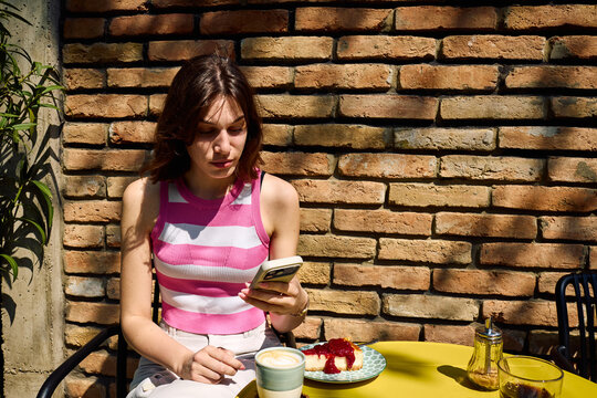 Young woman sitting in the confectionery garden