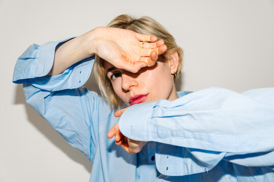 Woman posing with hand across face