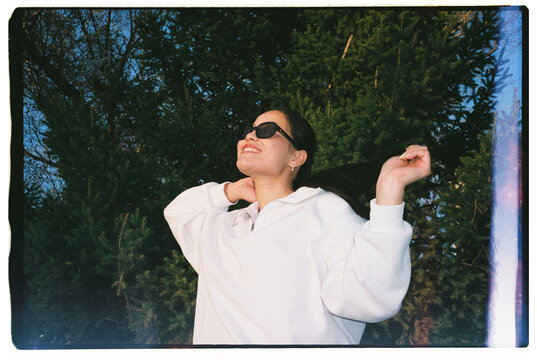 Happy Woman in Sunglasses Outdoors Near Trees