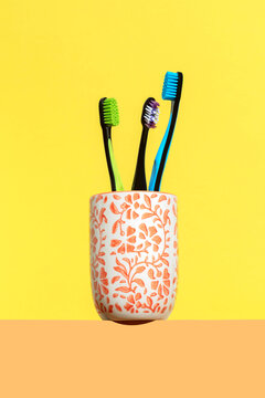 Colorful toothbrushes in ceramic holder