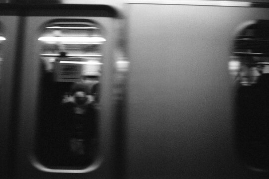 Blurred Subway Train Passing with Figures and Neon Light