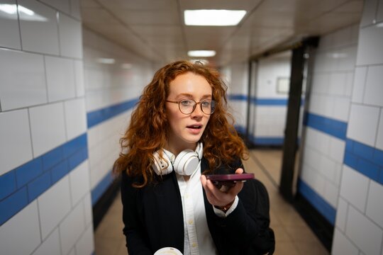 Woman recording voice message while commuting