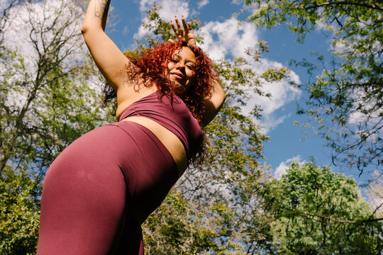 A woman dedicated to exercise works out outdoors on a sunny morning