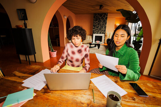 Colleagues collaborating on remote work project in home office