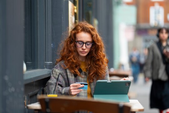 Woman using tablet at cafe table