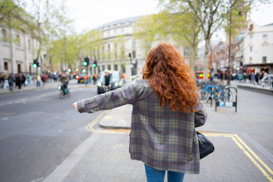 Hailing a taxi on London street