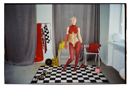 A woman poses in a studio