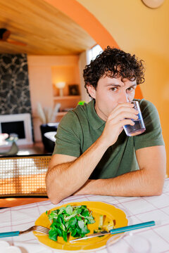 Man hydrating drinking water at home