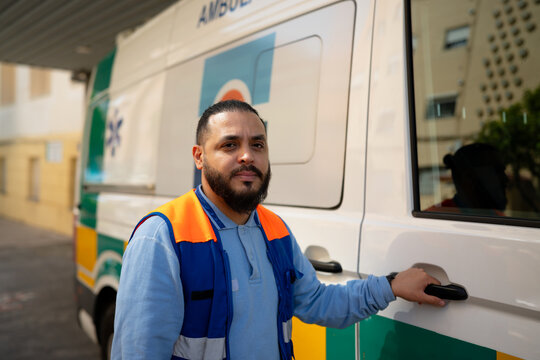Paramedic standing beside ambulance