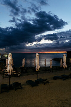Evening Tranquility at the Beach With Swaying Umbrellas 