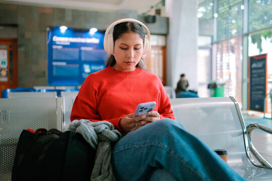 Woman using phone in station