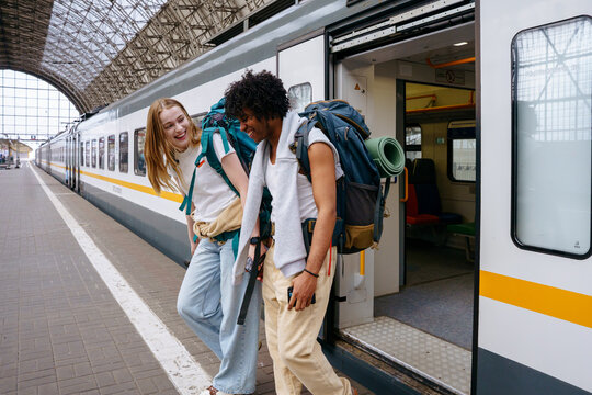 Backpackers at railway station before journey