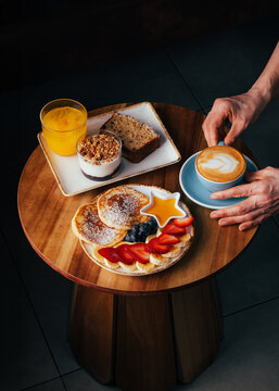 Cozy brunch table with latte, pancakes, and fruit