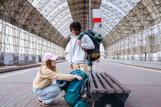 Backpackers meeting at railway station before journey