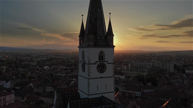 Aerial sunset 4k video of the Great Square in Sibiu, showing historic buildings, the Catholic and Lutheran Church, and the council tower, sunset landscape. Sibiu Transylvania landmarks. Romania video