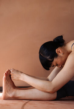 Woman Doing Seated Forward Bend Yoga Stretch